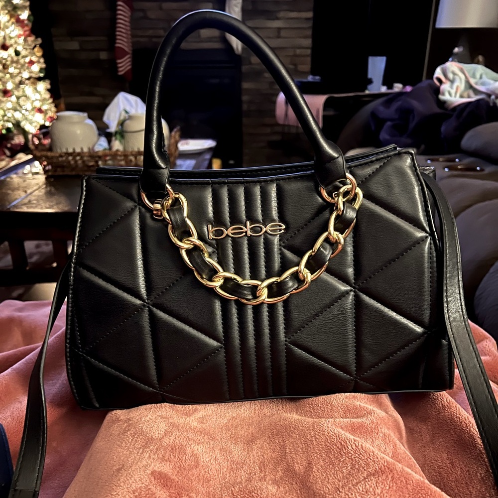 Bebe black, leather tufted medium purse with handles and strap. Like new.